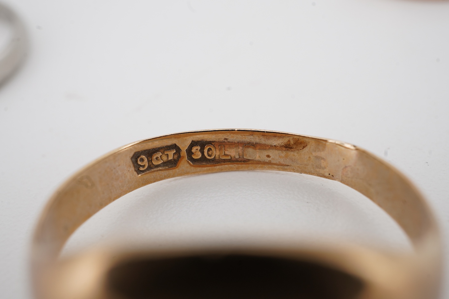 A 1940's platinum wedding band, with engraved inscription, size M, 2.3 grams together with a 9ct signet ring and a yellow metal wedding band.